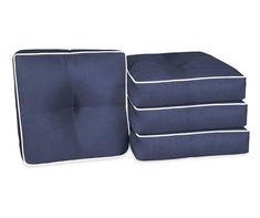 three blue cushions stacked on top of each other with white piping around the edges