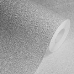 a roll of white paper on top of a table with a black and white background