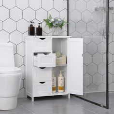 a white bathroom with hexagonal tiles on the wall