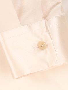 Khaite cream silk shirt with classic collar, button closure, button cuffs, curved hem. Composition: 100% Silk Elegant Silk Shirt With Concealed Placket, Elegant Silk Shirt With Hidden Button Closure, Luxury Silk Shirt With Concealed Placket, Luxury Cream Tops For Work, Luxury Cream Top For Workwear, Luxury Cream Top For Work, Classic Formal Blouse With Open Cuff, Elegant Button-up Shirt With Concealed Placket, Timeless Silk Shirt For Formal Occasions