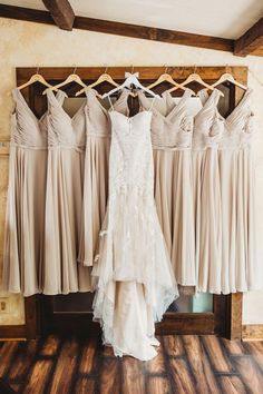 the bride's dress hangs in front of her bridal gowns