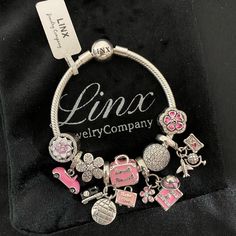 Linx Snake Chain Style Charm Bracelet With A Ball Clasp, Featuring Linx Logo. The Bracelet Comes With 9 Linx Charms As Shown. *All Items Are 925 Sterling Silver. *Linx Bracelets And Charms Are Very Well Made And Of Superior Quality, Designed To Last. These Pieces Come With A 100% Satisfaction Guarantee Or Your Money Back. *The Bracelet Is Available In Multiple Sizes *Additional Charms Can Also Be Added To The Bracelet And The Ones Included Are Removable As Well. *Linx Bracelets And Charms Are Un White Gold Metal Jewelry With Charms, White Gold Metal Bangle Charm Bracelet, Nickel-free Silver Snake Chain Jewelry, Silver Snake Chain Bracelet For Gift, Silver Snake Chain Bracelet As Gift, Silver Metal Bangle Charm Bracelet, Silver Metal Chain Bracelet With Dangling Charms, Silver Stainless Steel Charm Bangle Bracelet, Silver Stainless Steel Bangle Charm Bracelet