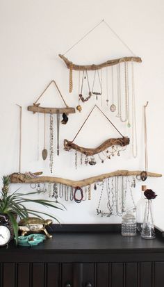 an image of a wall hanging with jewelry on it