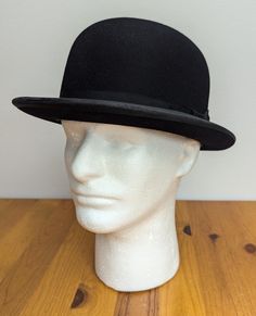 Vintage black fur felt boater hat. This hat is in nice shape overall, featuring a black grosgrain hatband, a leather sweatband inside, a bound rolled brim edge, and has a satin lining saying "Clark Mathis and Clarey, Chicago"; the tag stating this size has rubbed away, but it feels like a size 7 (small). There is general wear on the sweatband (logos are mostly worn away) and on some other edges due to age and wearing, but otherwise this remains in quite nice shape. The crown is 5 inches/13 cm. high, and the brim is 2 inches/5 cm. wide. This hat can be worn at a wide variety of events and is great for fall and winter. I have unfortunately been unable to find any information about the company, but it feels like it came from c. 1940s based on styling and materials (may be as early as 1930s ba Vintage Black Boater Hat With Curved Brim, Black Wide Brim Vintage Hat, Black Vintage Brimmed Top Hat, Vintage Black Wool Hats, Black Bowler Hat, Bowler Hat, Boater Hat, Hat Band, Melon