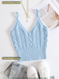 a blue knitted tank top next to jeans and shoes