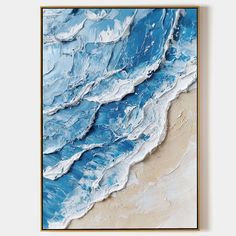 an abstract painting with blue and white waves on the beach, framed in wood frame