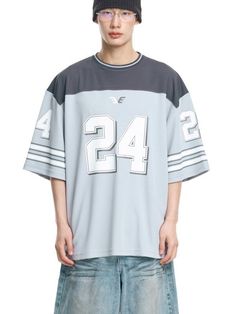 It is a short sleeves football jersey that is made of moisture-wicking and breathable fabric. The t-shirt has colorblock design and graphic print on the sleeves and front. The balloon oversized fit t-shirt makes casual and stylish outfit.- Balloon oversized fit- Stripes on sleeves- Graphic print- Stripe point on neck Athleisure Jersey T-shirt With Letter Print, Sporty Oversized T-shirt For Game Day, Blue Varsity Short Sleeve Jersey, Sporty Short Sleeve T-shirt For Sports Season, Blue Short Sleeve Varsity Jersey, Sporty White T-shirt With Number Print, Varsity Crew Neck Jersey, White Short Sleeve Jersey For Streetwear, Streetwear Jersey For Sports Season With Short Sleeves