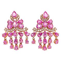 Sunita Nahata presents an exclusive collection of pink sapphire earrings. This particular earring showcases dangling sapphires and diamonds, and is constructed to fall elegantly on the wearer. Designer pink sapphire earring in 18K rose gold with diamonds. Pink Sapphire: 9.725 carat in various shapes and sizes. Diamonds: 0.78 carat, G colour, VS clarity. Gold: 11.496g, 18K rose gold. Sapphire Earring, Pink Sapphire Earrings, Pink Ruby, Aquamarine Earrings, Art Nouveau Jewelry, Naha, Sapphire Earrings, Rose Gold Diamonds, Dream Jewelry