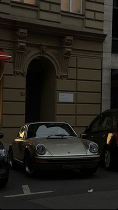 two cars parked in front of a building