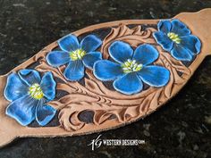 a wooden spoon with blue flowers painted on it