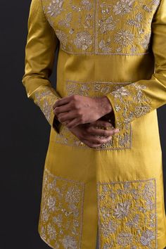 Gold long sleeves sherwani with all over flora garden embroidery with sequin highlights. Paired with a white churidar.
Components: 2
Pattern: Embroidered
Type Of Work: Flora Garden
Neckline: Mandarin Collar
Sleeve Type: Long
Fabric: Linen Satin, Satin Lycra
Color: Gold
Other Details: 
Approx weight: 3kgs
Poly lining
Occasion: Mehendi and Puja, Sangeet - Aza Fashions Cotton Silk Bandhgala With Resham Embroidery, Festive Cotton Silk Bandhgala With Resham Embroidery, Art Silk Straight Kurta For Reception, Transitional Bandhgala In Raw Silk With Chikankari Embroidery, Designer Raw Silk Bandhgala With Chikankari Embroidery, Designer Cotton Silk Bandhgala For Festivals, Sherwani With Resham Embroidery In Chanderi Fabric, Chanderi Sherwani With Resham Embroidery, Eid Cotton Silk Bandhgala With Dabka Work