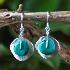 "Silver Cornflake Disc Earrings with Turquoise - Silver and Turquoise Earrings - Turquoise Earrings - Unusual Earrings Wavy \"cornflake\" beads plated in fine silver are topped with genuine turquoise rondelles in these turquoise drop earrings. They dangle from sterling silver French earwires. These silver and turquoise earrings are like a ray of summer sunshine and have proven to be one of the most popular earring styles offered in our Ambrosia Collection. Imported from Greece, the wavy \"cornfl Adjustable Turquoise Earrings With Ear Wire, Turquoise Round Pierced Jewelry, Turquoise Sterling Silver Earrings For Pierced Ears, Turquoise Earrings In Sterling Silver, Turquoise Round Sterling Silver Earrings, Artisan Turquoise Nickel-free Earrings, Artisan Nickel-free Turquoise Earrings, Artisan Turquoise Pierced Earrings, Turquoise Drop Earrings With Ear Wire