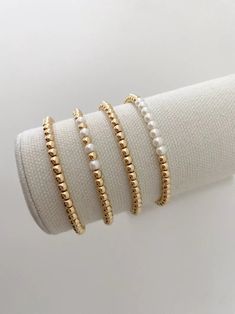 one 14k gold beaded bracelet with pearl accent beads bracelets are made on a durable stretch elastic cord please refer to our sizing guide before purchasing Bracelets Pearl, Jewelry Stack, Gold Beaded Bracelet, Multiple Bracelets, Preppy Jewelry, Pearl Bracelets, Stacking Bracelets, Gold Bead Bracelets, Stacked Jewelry