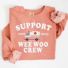 an orange shirt with the words support your local weewo crew on it and a pink bow