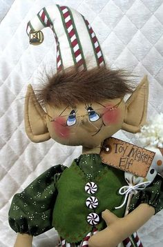 a close up of a doll holding a sign