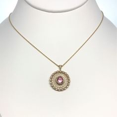 A Ladies 14K Yellow Gold 18 Inch Long Art Deco Inspired Necklace Set With A Round Pink Tourmaline That Weighs .83 Carats And 22 Round Diamonds Having A Total Weight Of .13 Carats. Elegant Oval Tourmaline Pendant, Yellow Gold Tourmaline Pendant Necklace, Yellow Gold Round Tourmaline Jewelry, Elegant Round Pink Sapphire Gemstones, Elegant Tourmaline Pendant Jewelry, Elegant Oval Tourmaline Necklace, Yellow Gold Tourmaline Gemstone Necklace, Luxury Pink Sapphire Round Jewelry, Exquisite Pink Gemstone Necklaces