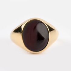 A beautiful Garnet signet ring - Recommended by Etsy! *real images of the ring, taken by us* Garnet Stone Size: 12x10mm Material: - 9K Gold (375) - 14K Gold (585) - 18K Gold (750) *All signet rings are hallmarked on the back for certification* - We offer FREE Worldwide DHL & FedEx Shipping! - Branded DanelianJewelry Gift Box with each order! Our customer service is available 7 days a week. Leave us your message, and we will get back to you within a little time. ✔️ Tracking number ✔️ Worldwide sh Luxury Red Signet Ring With Polished Finish, Formal Oval Signet Ring With Polished Edges, Modern Oval Cabochon Signet Ring For Formal Occasions, Classic Cabochon Opal Ring For Formal Occasions, Modern Oval Cabochon Signet Ring For Gift, Modern Oval Cabochon Signet Ring As Gift, Oval Cabochon Signet Ring With Polished Finish, Classic Yellow Gold Signet Ring With Cabochon, Classic Signet Ring With Polished Edges As A Gift