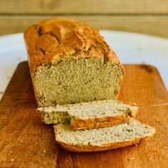 a loaf of banana bread sitting on top of a wooden cutting board