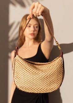 Indulge in luxury with our Woven Raffia Saddle Bag, expertly crafted with a blend of raffia and leather. Its adjustable shoulder strap ensures a perfect fit for women of all sizes. Elevate your style with this exclusive and elegant addition to your wardrobe. Size info 10 5/8" (27cm) width 6 3/4"(17cm) height 3"(8cm) depth Details Raffia and genuine cowhide leather Polyester lining Adjustable shoulder strap Interior wall pocket and zipper pocket Top zip closure Item #462501 Women's saddle shoulde Luxury Natural Straw Bag With Gold-tone Hardware, Luxury Bucket Bag With Gold-tone Hardware For Summer, Luxury Summer Bucket Bag With Gold-tone Hardware, Elegant Straw Bag With Gold-tone Hardware For Daily Use, Natural Color Hobo Shoulder Bag With Detachable Strap, Natural Hobo Shoulder Bag With Detachable Strap, Chic Satchel Straw Bag With Detachable Strap, Luxury Summer Shoulder Bag With Detachable Strap, Elegant Satchel Straw Bag