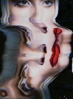 a woman's face is reflected in the water with red lipstick on her lips