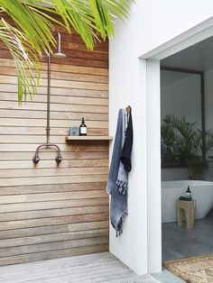 the outside of a house with a wooden wall and planter on it's side