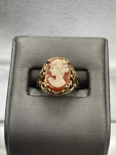 This ring is made in 10 karat yellow gold in a beautiful open scroll design work with a striking cameo on top.  The cameo is carved with amazing detail.   Weight:  4.1 grams Ring Size:  6 ¼  Our Price $425.00 Regularly Priced At $675.00 Please See Our Video Remember - If you're purchasing for yourself or a gift for a loved one, buy with confidence.  We Guarantee Everything We Sell!  SKU # R927 Classic Oval Cameo Rings, Victorian Cameo Rings For Anniversary, Victorian Gold Cameo Rings, Cameo 14k Gold Rings For Anniversary, 14k Gold Cameo Ring Fine Jewelry, 14k Gold Cameo Round Jewelry, Cameo 14k Gold Rings For Collectors, 14k Gold Cameo Rings For Collectors, 14k Gold Cameo Ring