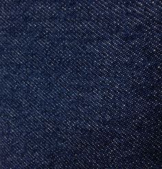 the texture of blue denim fabric with white dots is shown in this close up photo