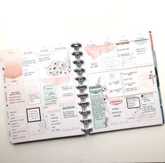 an open planner book sitting on top of a table