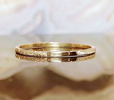 1mm Solid 10K 14K Yellow Gold Slim Round Wedding Band or Skinny Stacking Ring Beautiful super slim band ring. Each ring is carefully hand crafted in our workshop.  Perfect as a cute and dainty wedding band and they look great stacked together with other rings if being worn as a stylish fashion ring. 1. **Pure Luxury Crafted from genuine 14k or 10k gold, this band exudes pure luxury with its high-quality material. 2. **Unmatched Quality Unlike alternatives, every inch of this band is solid 14k or Amber Ring Gold, Midi Rings Gold, Dainty Wedding Band, Delicate Gold Ring, Pink Stone Rings, Gold Pinky Ring, Hammered Rings, Midi Ring, Jewelry Wedding Rings