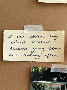 a piece of paper that has been pinned to a bulletin board with writing on it