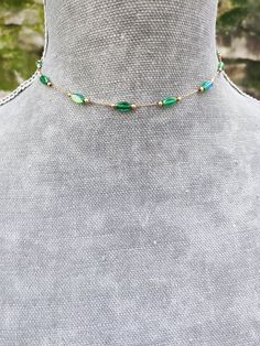 Super dainty emerald green crystal beaded choker made of gold plated stainless steel and beautiful little long ab green crystals. PLEASE read my shop announcement before placing an order so you know what to expect right now. Plus, when ordering from outside Europe, don't forget to provide a phone number for the courier to ensure the fastest and smoothest delivery Stainless steel chain and findings, won't rust or anything  Fastens with a solid lobster clasp, and has an extension chain.   Choker is 13 inches long and comes with an extension chain, but I can make it in your desired length, just ask me. ✨ Another super dainty double chain choker here: https://www.etsy.com/listing/1684657649/dainty-satellite-chain-choker-necklace All my jewelry is nickel and lead free.  I'm so sorry for having Green Dainty Clavicle Chain Necklace, Beaded Chain Choker Jewelry As Gift, Wire Wrapped Choker For Party, Green Delicate Chain Jewelry For May Birthstone, Handmade Dainty Choker Chain Necklace, Dainty Green Jewelry With Delicate Chain, Green Emerald Jewelry With Delicate Chain, Dainty Handmade Choker Chain Necklace, Gold Emerald Jewelry With Delicate Chain