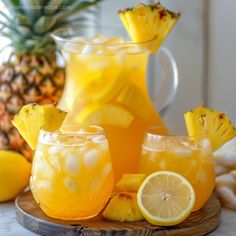 two glasses filled with lemonade next to sliced pineapples