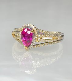 Ruby Ring, Ruby Diamond Ring For Women, Pear Shaped Ruby Engagement Ring, Pear Shaped Ruby Ring, Gemstone Engagement Ring, OOAK Ruby Ring A graceful and delicate pear shaped ruby ring featuring a bright and vibrant center stone weighing 0.96 carats accented by 0.76 carats of diamonds white intricately detailed and set in 14k two toned solid gold. *Approximate right weight: 3.13 grams * Ring size: US 6 1/2 * Complimentary resizing is available up to 3 sizes larger or smaller than stated size. Pink Pear-shaped Gemstone Rings, Pink Teardrop Fine Jewelry Ring, Pink Teardrop Jewelry With Center Stone, Pear-shaped Halo Setting Promise Ring, Teardrop Halo Ring In Fine Jewelry Style, Teardrop Diamond Accent Promise Ring, Dazzling Pear-shaped Ring With Accent Stones, Teardrop Diamond Accented Promise Ring, Pear Shaped Promise Ring In Fine Jewelry Style