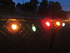 the traffic lights are all red, green, and yellow on this fenced in area