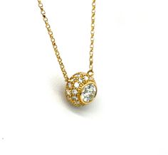 This 18 karat yellow gold bezel and pave set pendant has a .50 carat GIA# 2195570029 .50 carat round center stone graded I in color and SI2 in clarity with a very good cut. It is surrounded by .44 carats of round brilliant stones pave set and graded H in color and SI1 in clarity. The chain is a classic cable at it is 16 inches in length. 9.15 mm in diamter and the total Diamond weight is .94 carats. Gold Solitaire Necklace With Round Diamond, Gold Solitaire Necklace With Diamond Accents And Round Stone, Dazzling Yellow Gold Round Solitaire Necklace, Round Diamond Solitaire Necklace With Pave Setting, Fine Jewelry Solitaire Necklace With Pave Setting, Classic Round Solitaire Necklace With Pave Setting, Round Solitaire Necklace With Pave Setting, Round Solitaire Necklace With Pave Setting For Formal Events, Yellow Gold Diamond Necklace With Halo Setting