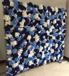 a blue and white crocheted wall hanging in a room with tile flooring