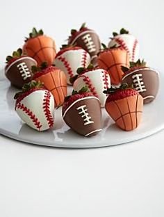 chocolate covered strawberries are arranged in the shape of footballs and strawberrys on a white plate