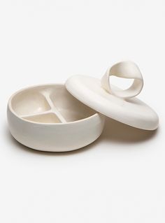 two white bowls sitting next to each other