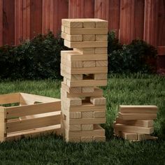 several wooden blocks stacked on top of each other in the grass