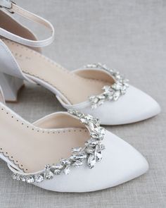 Classic satin almond toe block heels embellished with our glistening vine marquise rhinestone crystals across the front. The shimmering embellishment contrasted against the beautiful satin colors gives an ultra-chic look for any bride and bride squad.DETAILS:HEEL HEIGHT: 2.75 inchesUPPER: Synthetic upper and liningMATERIALS: Manmade outsoleSTYLE NAME: SALLY Block Heel Wedding Shoes, Satin Colors, Shoes Editorial, White Block Heels, Ivory Wedding Shoes, Flower Girl Shoes, Bridal Flats, White Wedding Shoes, Satin Shoes