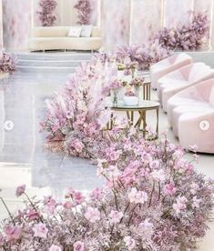 a room filled with lots of pink furniture and flowers