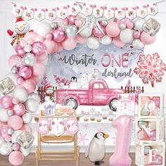 a pink and white birthday party with balloons, streamers, decorations and an ice skating theme