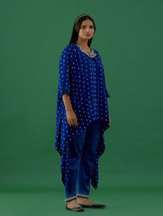 One of our timeless classics, hand-stitched exclusively for your bespoke taste. Channel your desi diva vibes and experience luxury in our all-time favourite festive collection. Royal Blue Bandhani Modal Satin Asymmetric Tunic featuring all-over bandhani work, a round neck, quarter sleeves, and embellished shoulders with ghungroos. Fabric: Modal Satin Color: Royal blue Note: Bottoms shown in the image not included with the tunic. Bottom can be bought separately Available in other colors The produ Satin Tunic, Asymmetric Tunic, Festive Collection, Satin Color, Best Deal, Quarter Sleeve, Hand Stitched, Hand Stitching, Desi