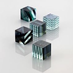 five glass cubes sitting on top of each other