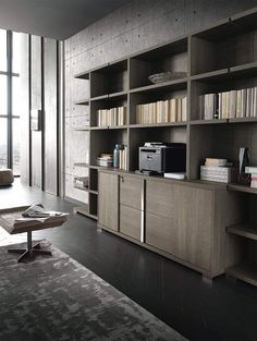 a living room filled with lots of furniture and bookshelves next to a window