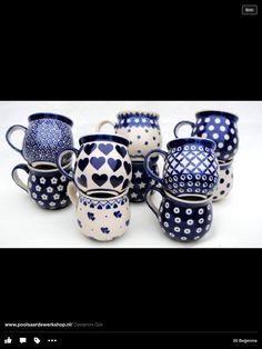 a group of blue and white vases sitting next to each other