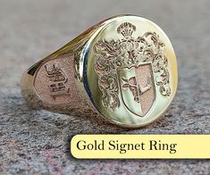 "At our store, we offer a range of exquisite \"Family Crest Ring\" and \"Coat of Arms Ring\" options that are fully customizable to capture the unique identity and history of your family. Family crests and coats of arms have been an essential part of family tradition for centuries, symbolizing the lineage and cultural significance of a family.  Our rings are meticulously crafted by skilled artisans, featuring your family crest or coat of arms engraved on a stunning gold or silver band, and adorned with a variety of precious stones such as emeralds, rubies, sapphires, onyx, aquamarine, and lapis. Our rings are not only a remarkable family heirloom, but also make a meaningful and sentimental gift for both men and women. We take pride in offering customization options that allow you to create Luxury Wedding Engraved Intaglio Ring, Luxury Oval Signet Ring With Coat Of Arms, Pinky Signet Ring Family Crest, Luxury Heirloom Signet Ring With Coat Of Arms, Luxury Signet Ring With Coat Of Arms, Luxury Vintage Signet Ring With Coat Of Arms, Luxury Anniversary Signet Ring With Coat Of Arms, Luxury Engraved Ring With Coat Of Arms As Gift, Luxury Engraved Ring With Coat Of Arms