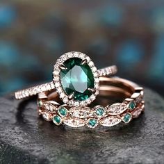 two wedding rings with green and white stones