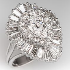 This beautiful ring is centered with one (1) pear brilliant cut diamond weighing 1.04 carats that is set into four-prong claw style setting. The center stone is bordered with thirteen (13), prong set, round brilliant cut diamonds and thirty (30), prong set, tapered baguette cut diamonds. The ring measures 23.0mm at the top, rises 9.8mm above the finger, tapering to 3.5mm wide and 0.8mm thick at the base of the shank. It is currently a size 6. Wedding Rings Double Halo, Halo Wedding Rings Sets, Double Halo Ring, Rings Antique, Antique Diamond Rings, Double Halo, Baguette Cut Diamond, Antique Diamond, Pear Diamond