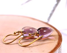 "Inverted teardrops in gorgeous purple amethyst are just so pretty. This upside down gemstone style is very high end and this pair is set with gold vermeil peg and cup style findings and hung from small vermeil wires. Awesome addition to your jewelry collection, very feminine, and a great gift for all ages. Stone is 8x12mm, earrings measures 1.25 inches. return to shop all items: http://www.etsy.com/shop/amyfine ask me anything you like here: http://www.etsy.com/convo_new.php?to_username=amyfine Purple Gemstone Teardrop Earrings, Handmade Amethyst Teardrop Earrings, Teardrop Amethyst Earrings As Gift, Amethyst Teardrop Earrings For Gift, Teardrop Amethyst Earrings For Gift, Gift Amethyst Teardrop Earrings, Teardrop Purple Earrings With Natural Stones, Purple Teardrop Earrings With Natural Stones, Amethyst Gemstone Teardrop Earrings Gift